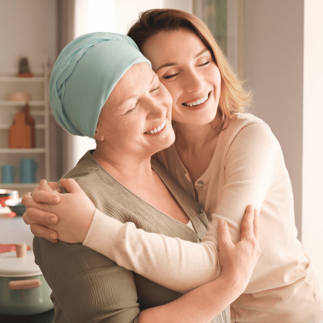 two women smiling and hugging