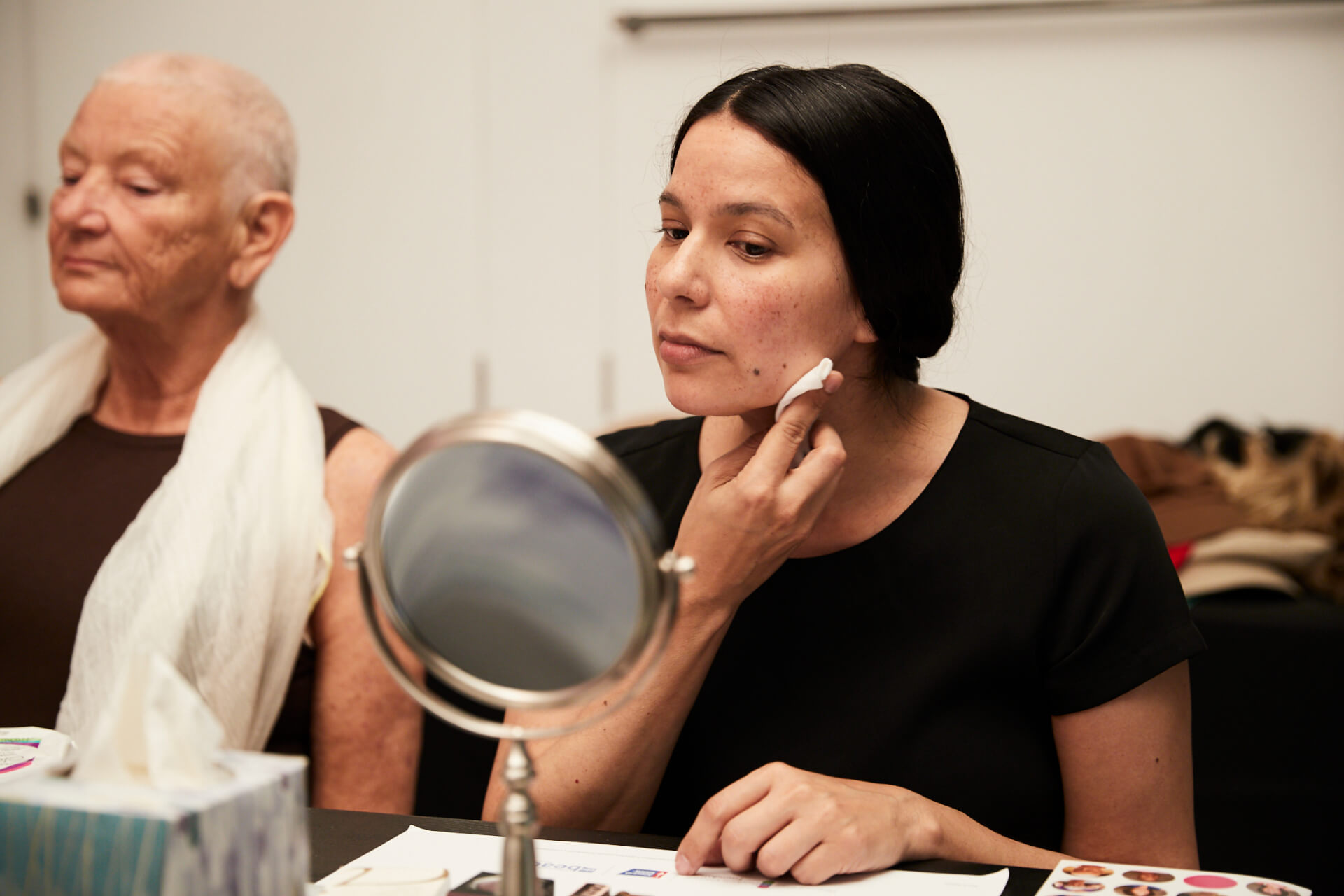 woman removing makeup from her face