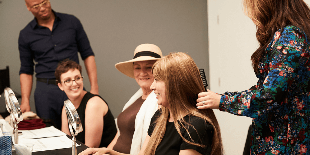 woman in a workshop getting her hair brushed