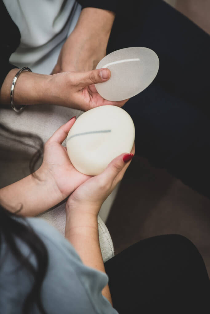 Plastic surgeon and patient discuss choice of breast implants after mastectomy or for breast augmentation.