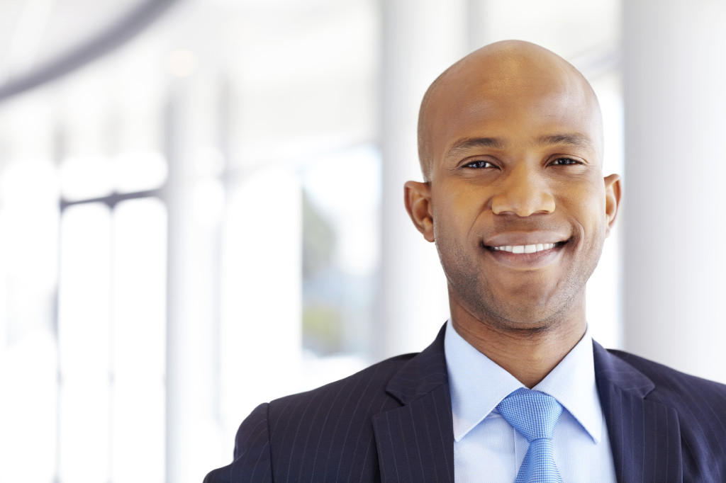 Portrait of an African American male corporate executive smiling. Horizontal shot.